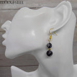 Boucles d'oreilles pendantes dorées deux perles en obsidienne mouchetée