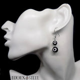 Boucles d'oreilles argentées deux perles mauvais oeil noires et blanches en acier inoxydable