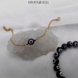 Bracelet chaîne dorée et bracelet en perles mauvais oeil noires et blanches