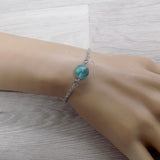 Bracelet en acier argenté et sa perle de fluorite bleue pierre naturelle