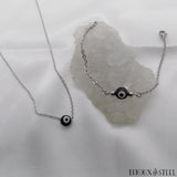Bracelet et collier chaîne argentée à perle mauvais oeil noir et blanc en acrylique et acier inoxydable