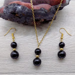 Parure boucles d'oreilles et collier dorés doubles perles en onyx noir