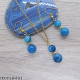 Parure dorée deux perles d'agate bleue et acier inoxydable