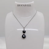 Pendentif argenté deux perles mauvais oeil noir et blanc en acier inoxydable