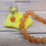 Bague large argentée et bracelet en perles d'aventurine orange