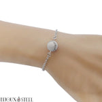 Bracelet en acier inoxydable argenté et sa perle d'howlite naturelle 10mm