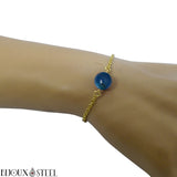 Bracelet en acier chirurgical doré et sa perle d'agate bleue teintée 10mm