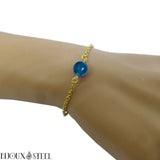 Bracelet en acier chirurgical doré et sa perle d'agate bleue teintée 8mm