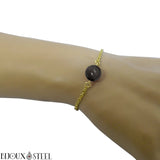 Bracelet à fine chaine dorée en acier chirurgical et sa perle d'obsidienne argentée 10mm en pierre naturelle