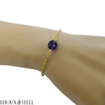 Bracelet en acier chirurgical doré et sa perle de fluorine violette 8mm