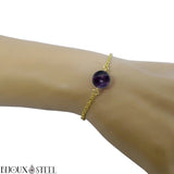 Bracelet en acier chirurgical doré et sa perle de fluorine violette 10mm